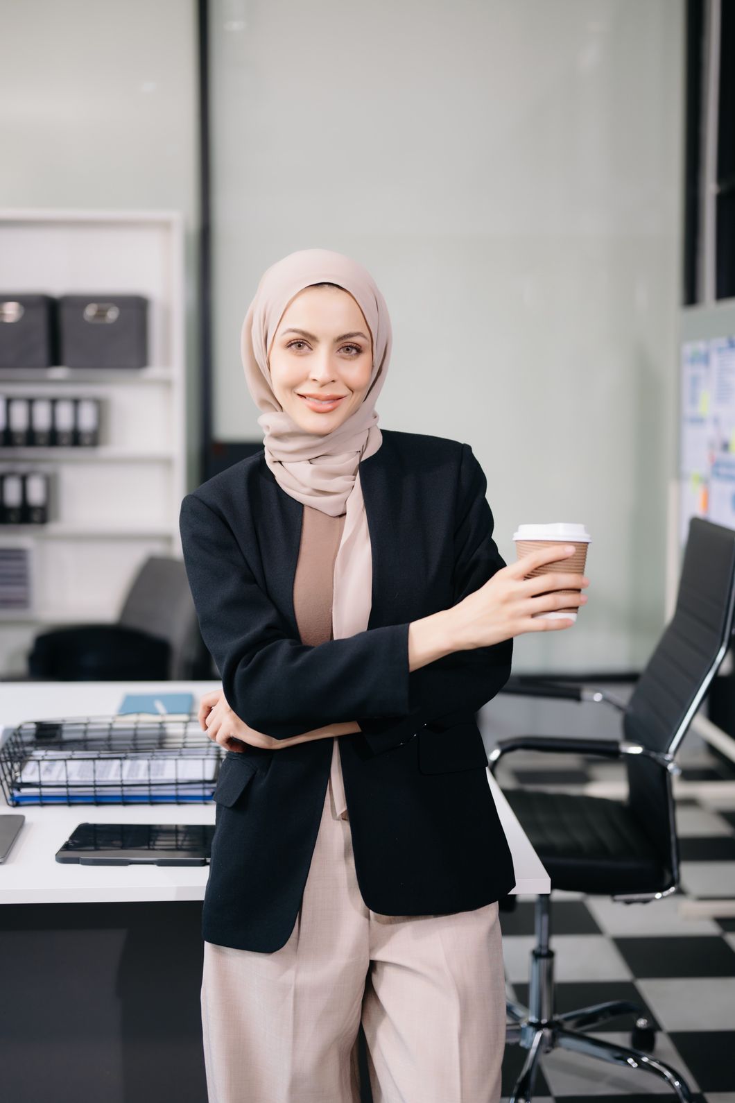 Female Entrepreneur Looking At The Camera While St FQVY956