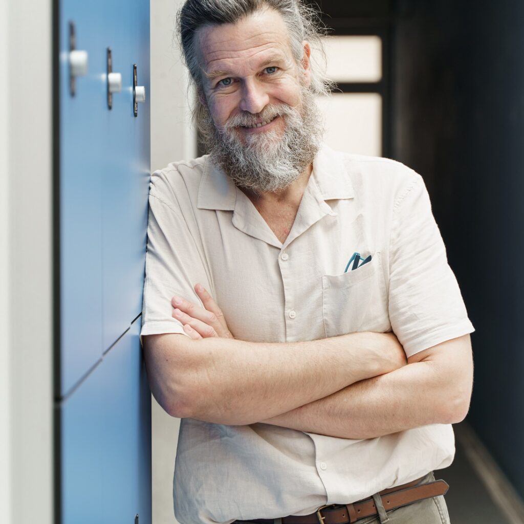 Middle Aged Male Teacher With Beard Standing In Sc GKZ724K 1024x1024