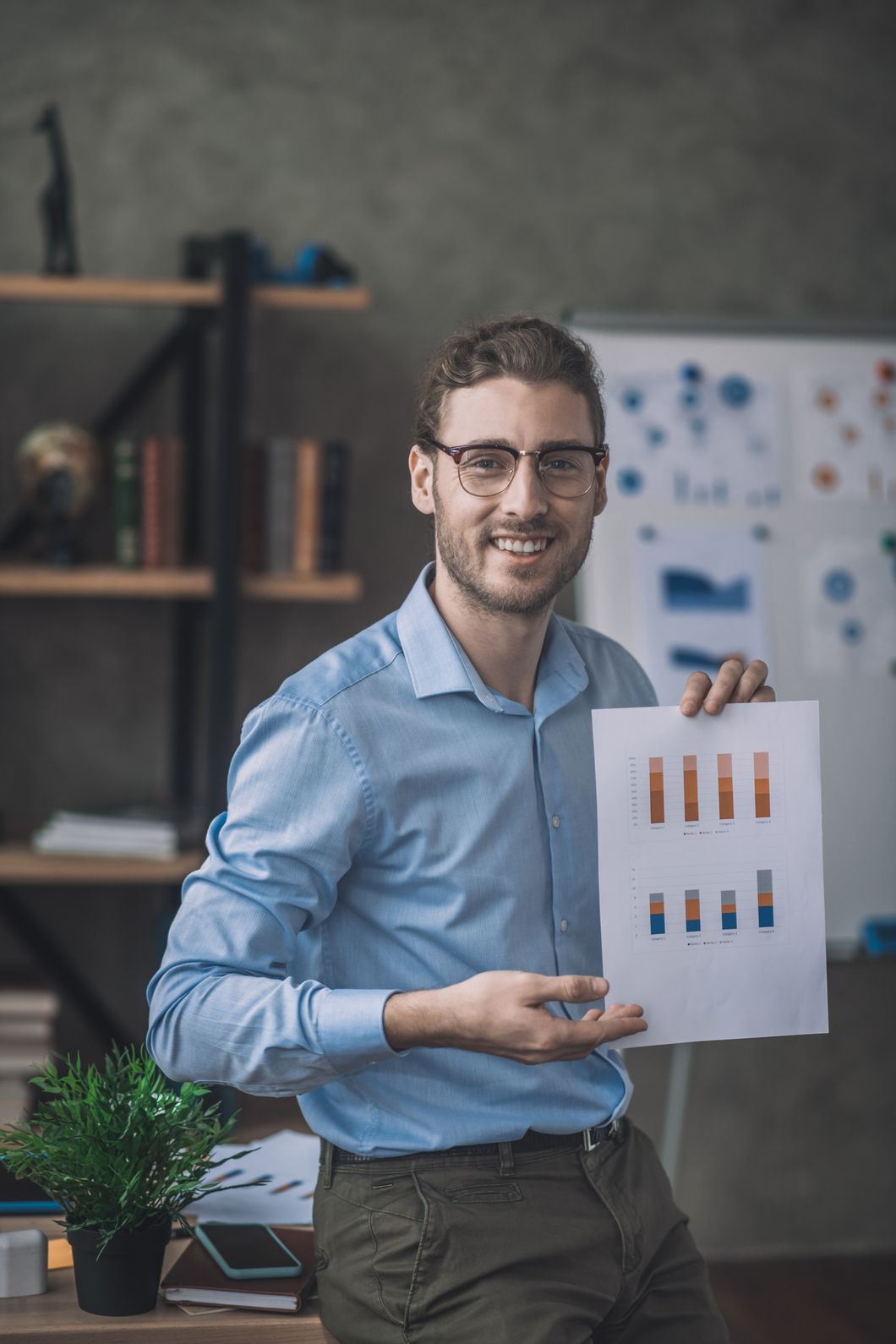 Young Bearded Man In Blue Shirt Showing A Draft SASZTJH